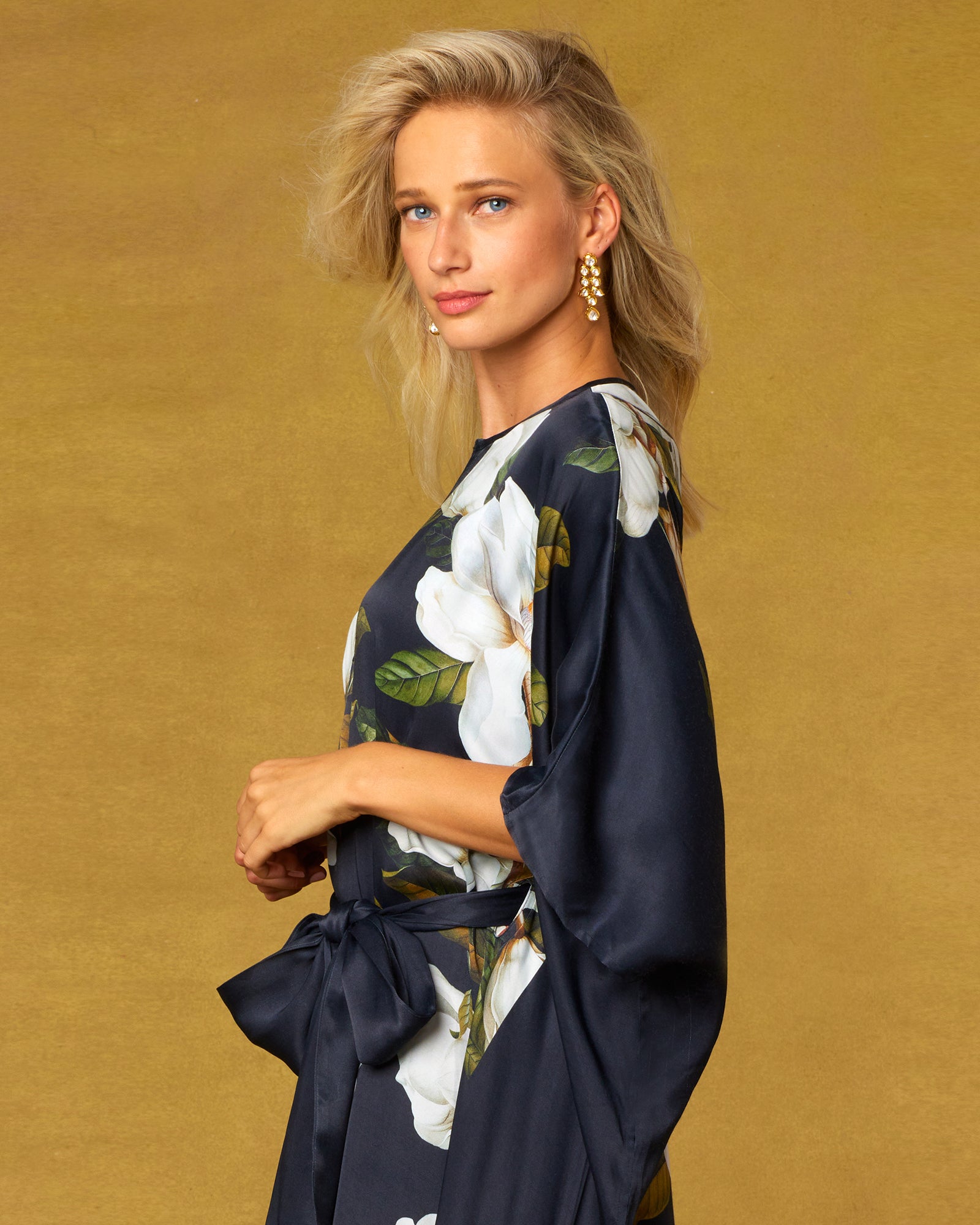 Portrait of a woman weraing the Camellia Belted Silk Kaftan