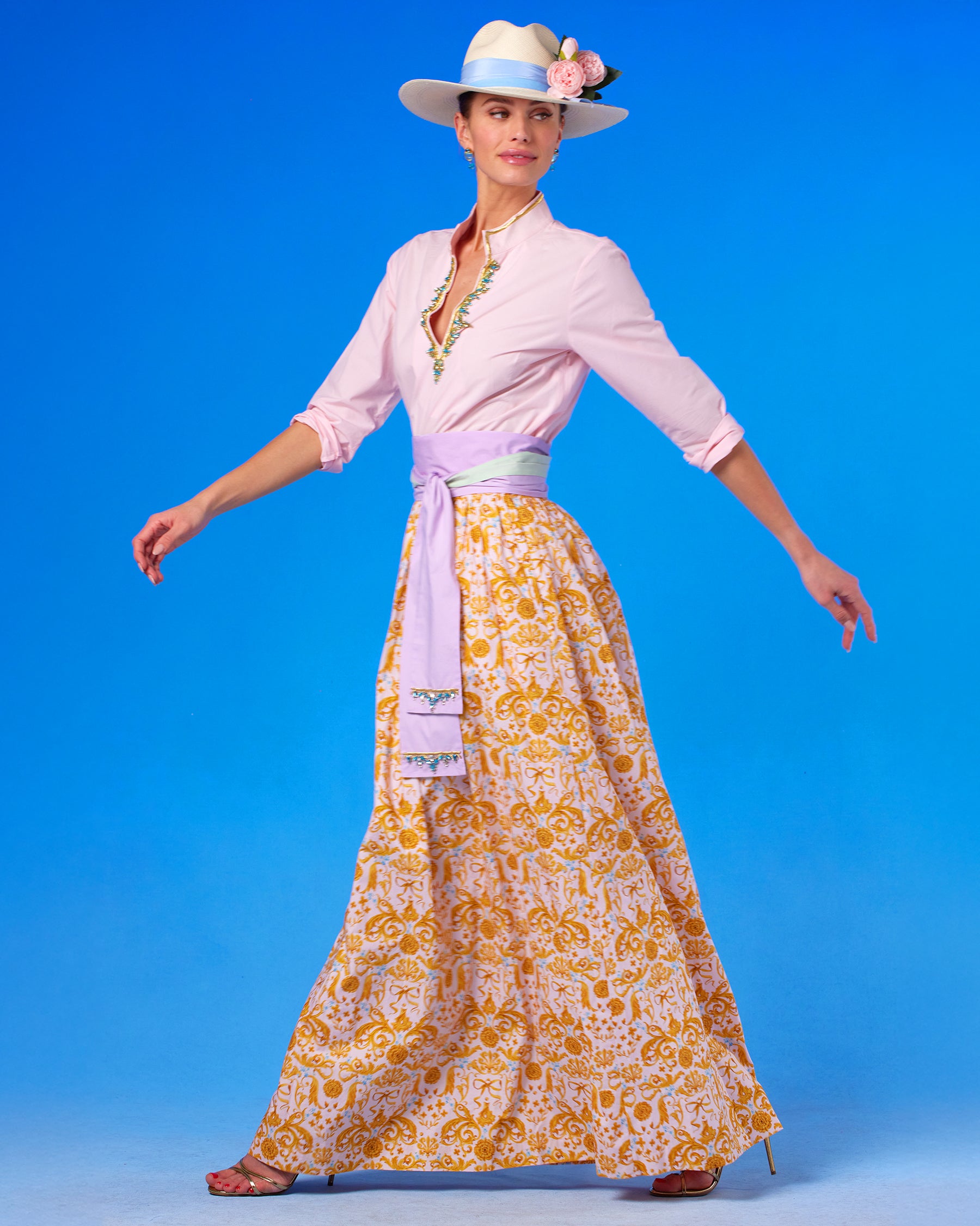 The Circe Reversible Sash Belt in Sunset Lavender and Ambrosia Green worn with the Circe Tunic in Blush Pink with Crystals and Gold Embroidery and Alexandra Long Full Skirt in Blush Pink Regency Ribbons side view walking