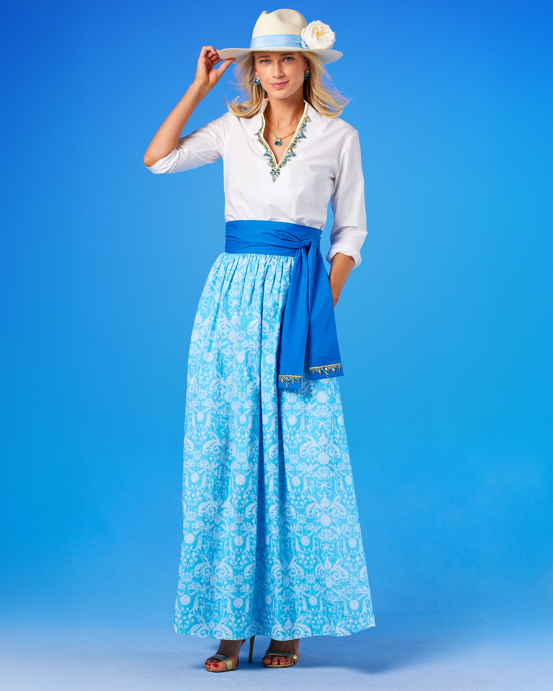 Alexandra Long Full Skirt in Porcelain Regency Ribbons worn with the Circe Tunic in Pure White with Crystals and Gold Embellishment with theCirce Reversible Blue Sash Belt Embellished with Crystals and Gold