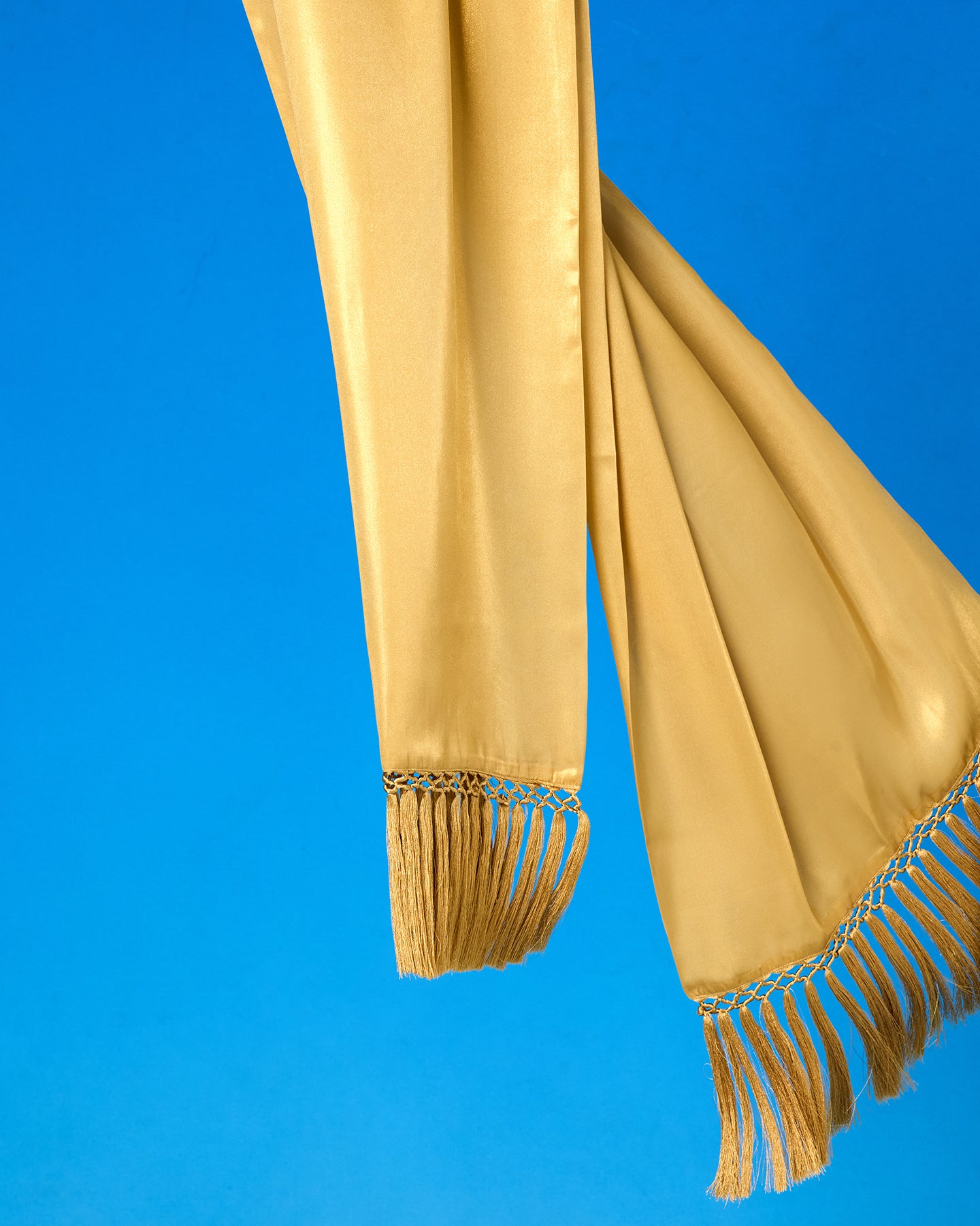 Arabella Fringe Shawl in Pale Gold Shimmer blowing in the wind