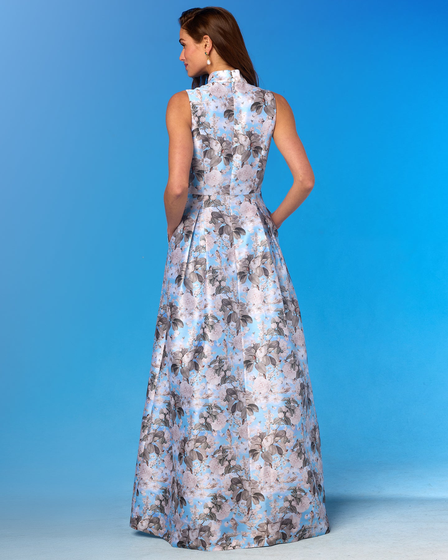 Woman wearing a floral dress against a blue background