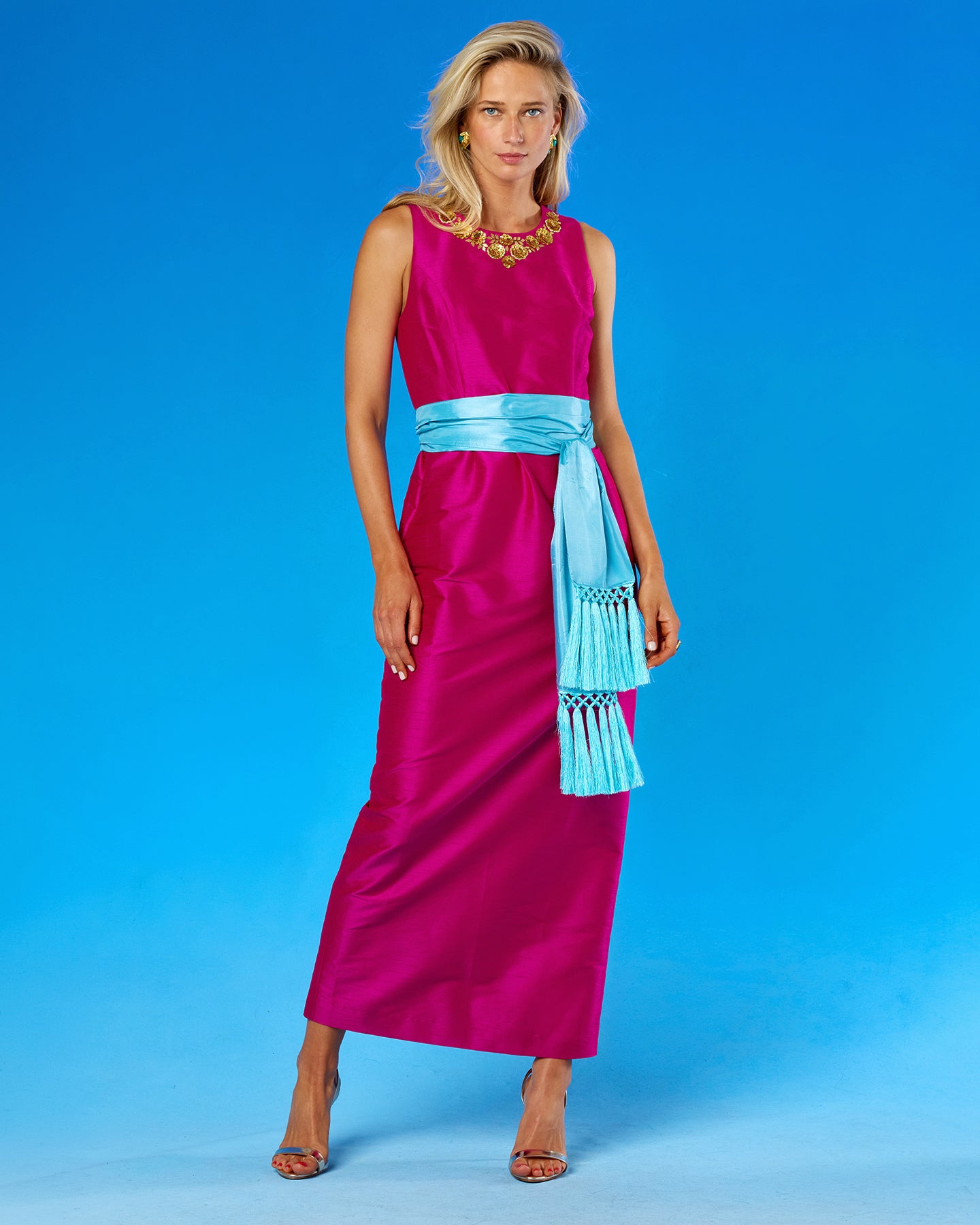 The Cosima Sash Belt in Bermuda Turquoise worn with the Cassandra Long Sheath Dress in Fuchsia and Gold Floral Embellishment