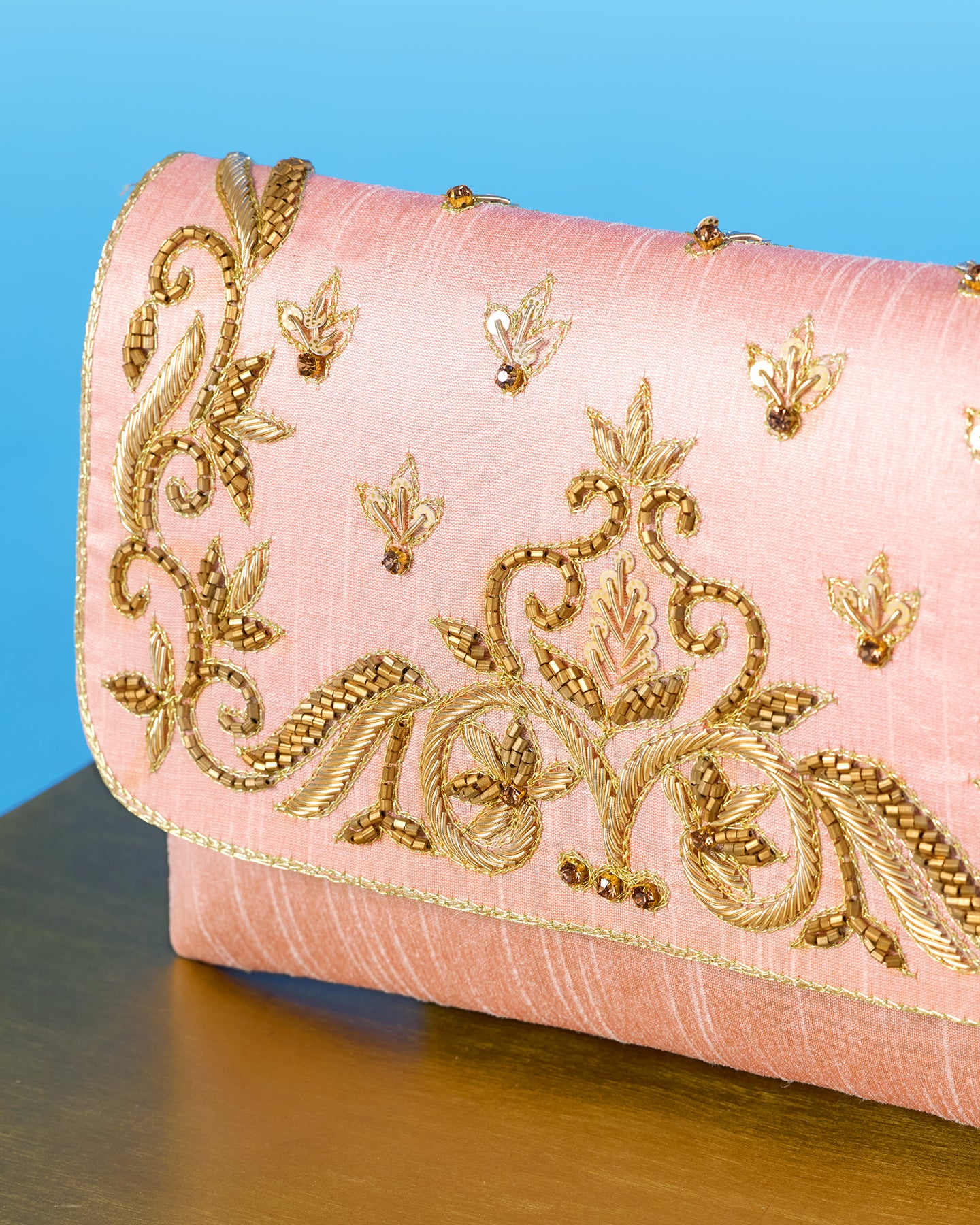 The Corelia Clutch in Blush Pink and Gold Embellishment closeup side view