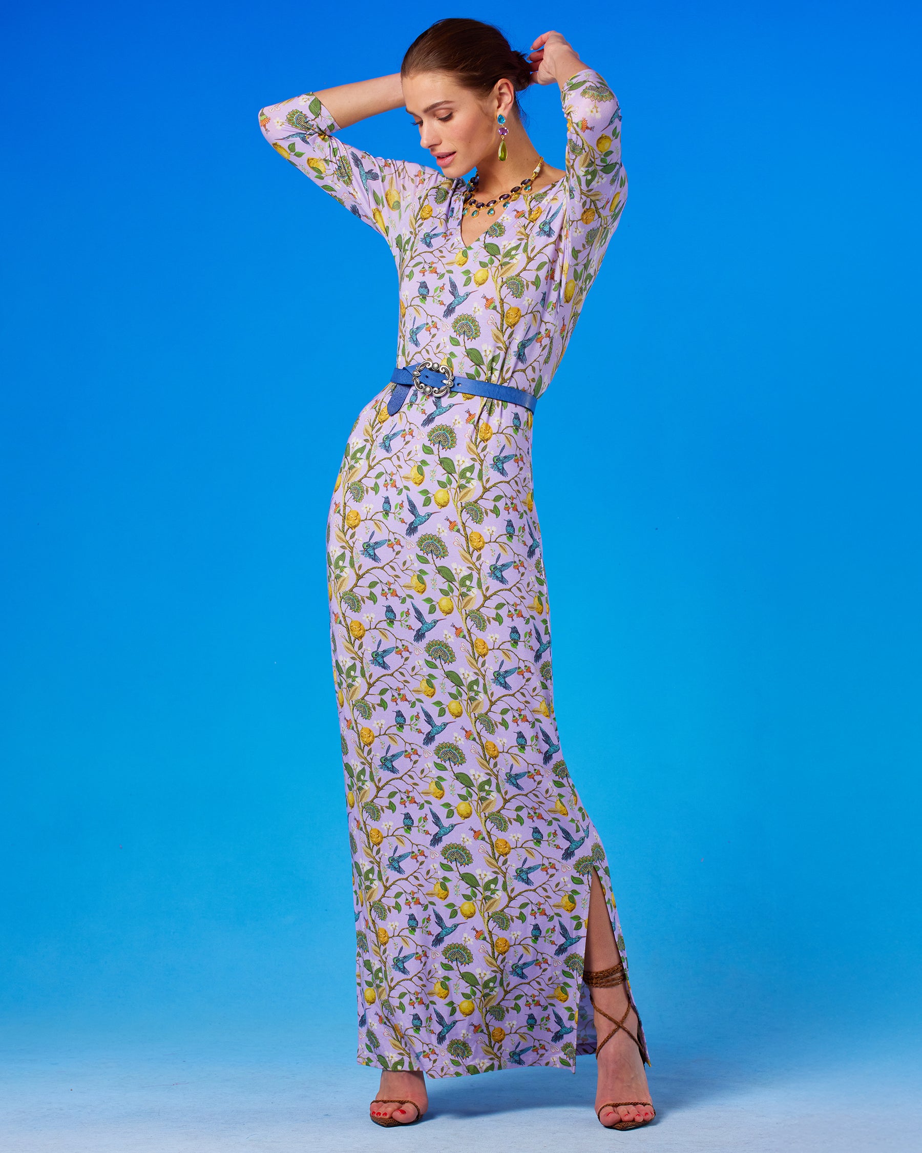 Flora Long Stretch Dress in Lavender Hummingbird Print arms up and looking down