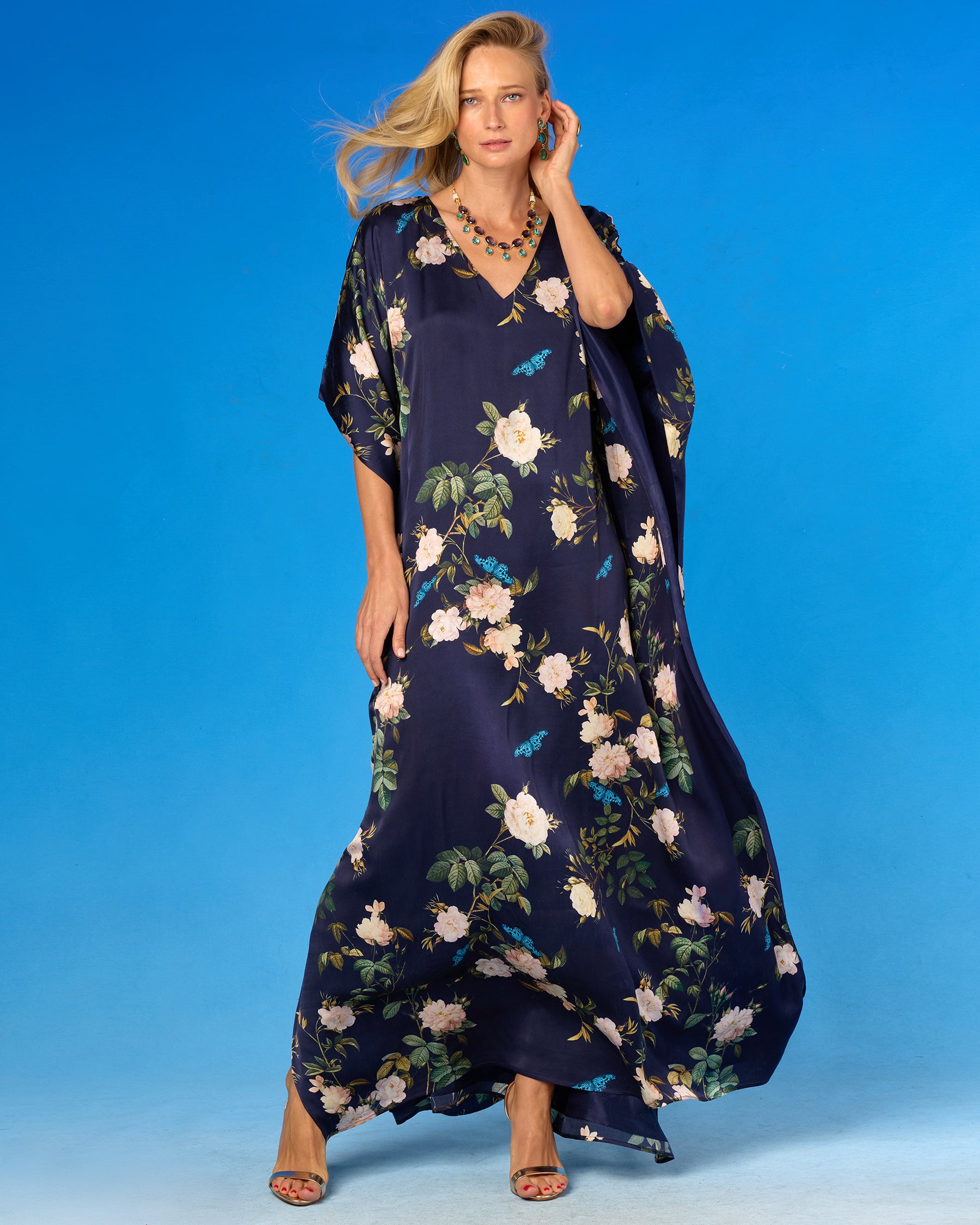 Gwendolyn Silk Kaftan in Navy English Garden front view with kaftan blowing in the wind