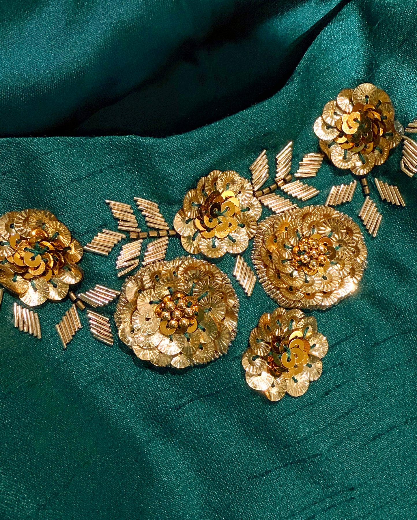 Detail of the hand-crafted embellishment on Isolde Strapless Gown in Emerald Green