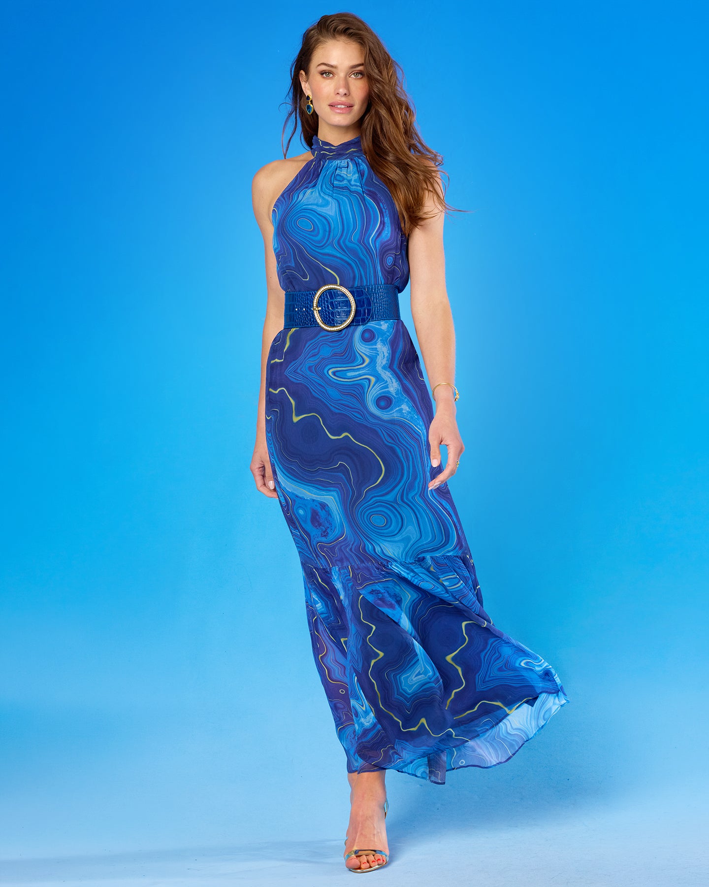 Woman wearing a blue patterned dress against a blue background