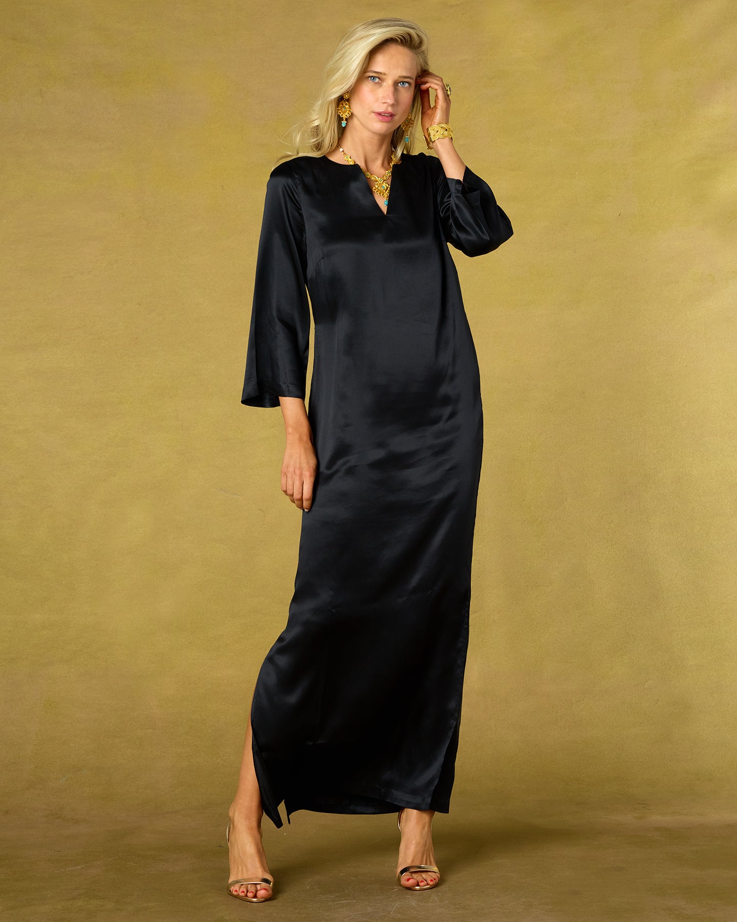 Woman wearing a black dress against a beige background