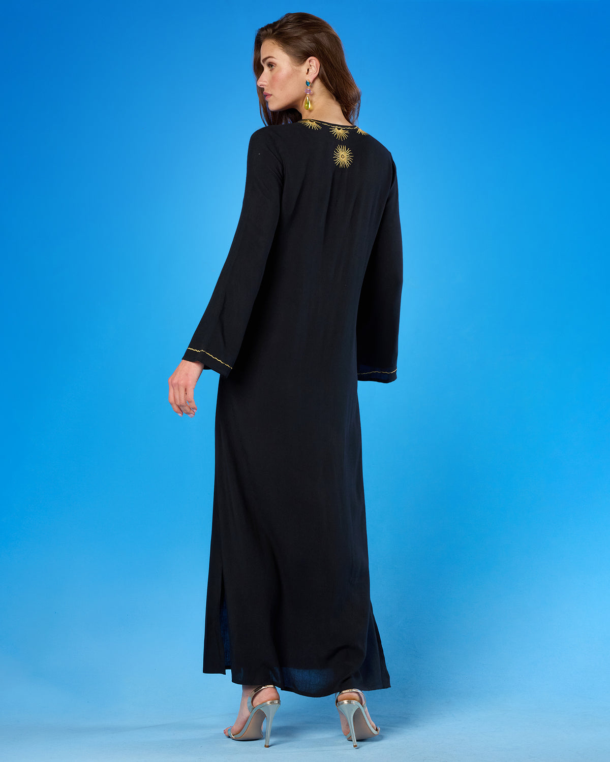 Woman wearing the Soleil Long Kaftan Coverup Dress and in Black and Gold Embroidery viewed from the back