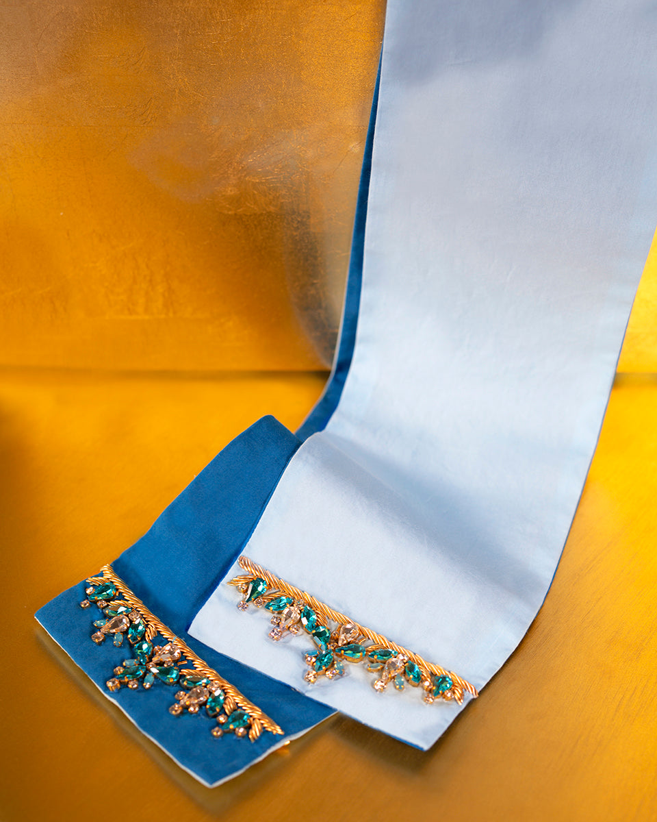 Detail of the Circe Reversible Sash Belt showcasing its two colors -azul and robin egg blue- and hand embellished jewels