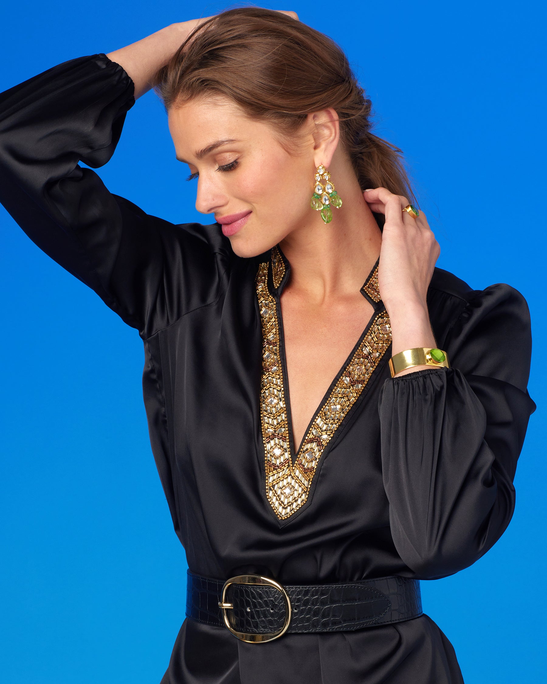 Portrait of model wearing the Anastasia Blouse in Black and Art Deco Embellishment-Arms Up and looking to the side
