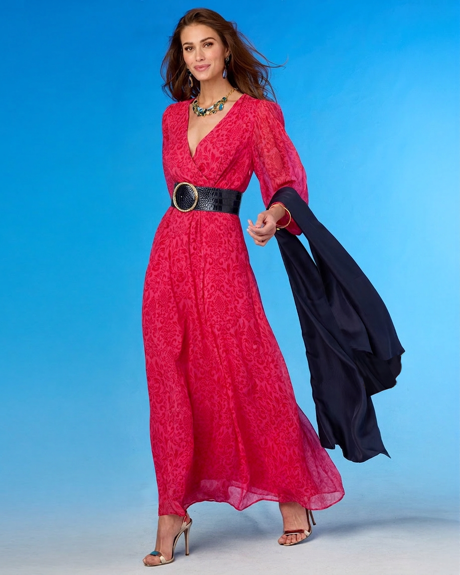 Woman in a red dress with a black belt holding a black jacket against a blue background