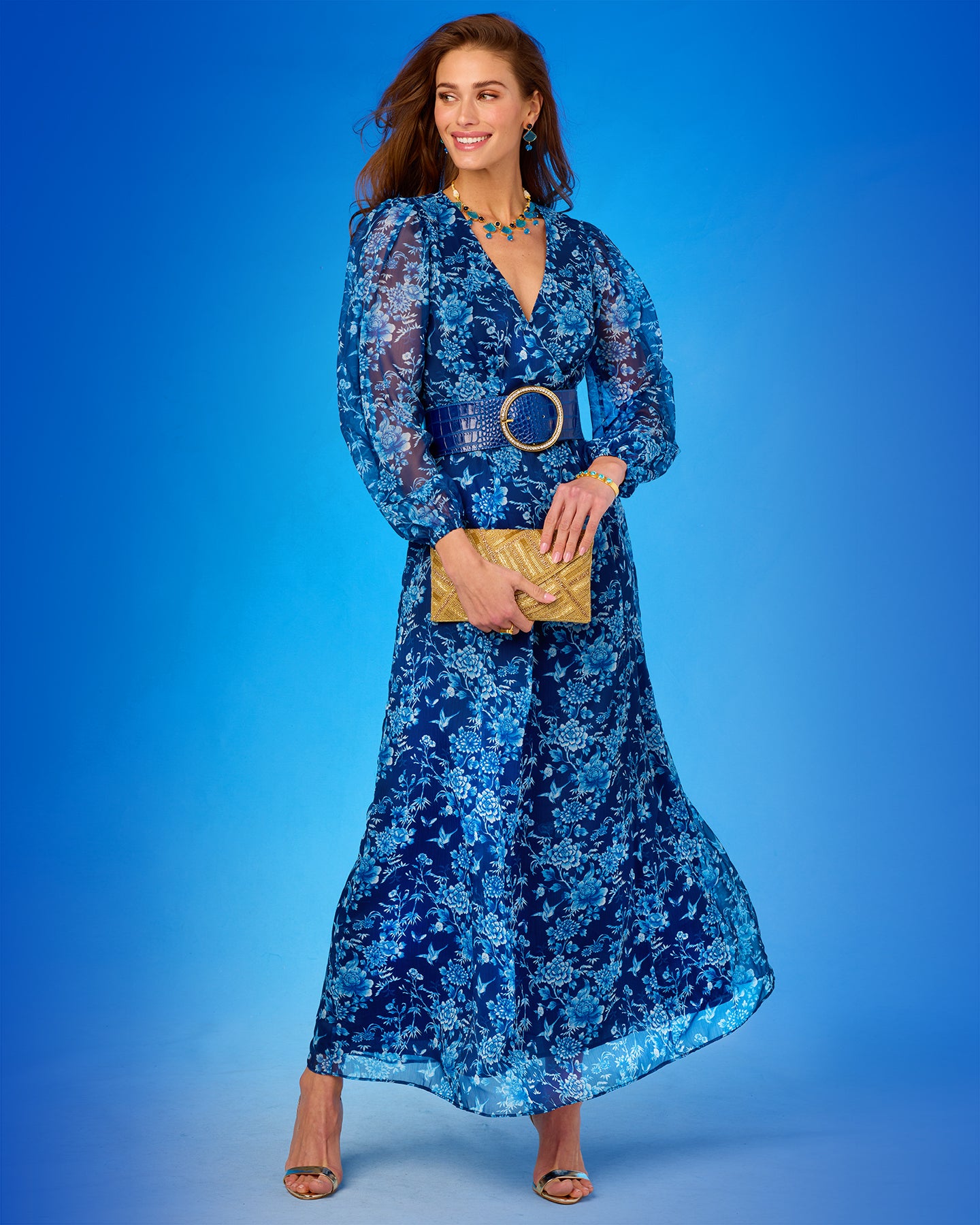 Angelina Maxi Crinkle Chiffon Dress in Navy Florals full length with the Betty Gold Beaded Clutch