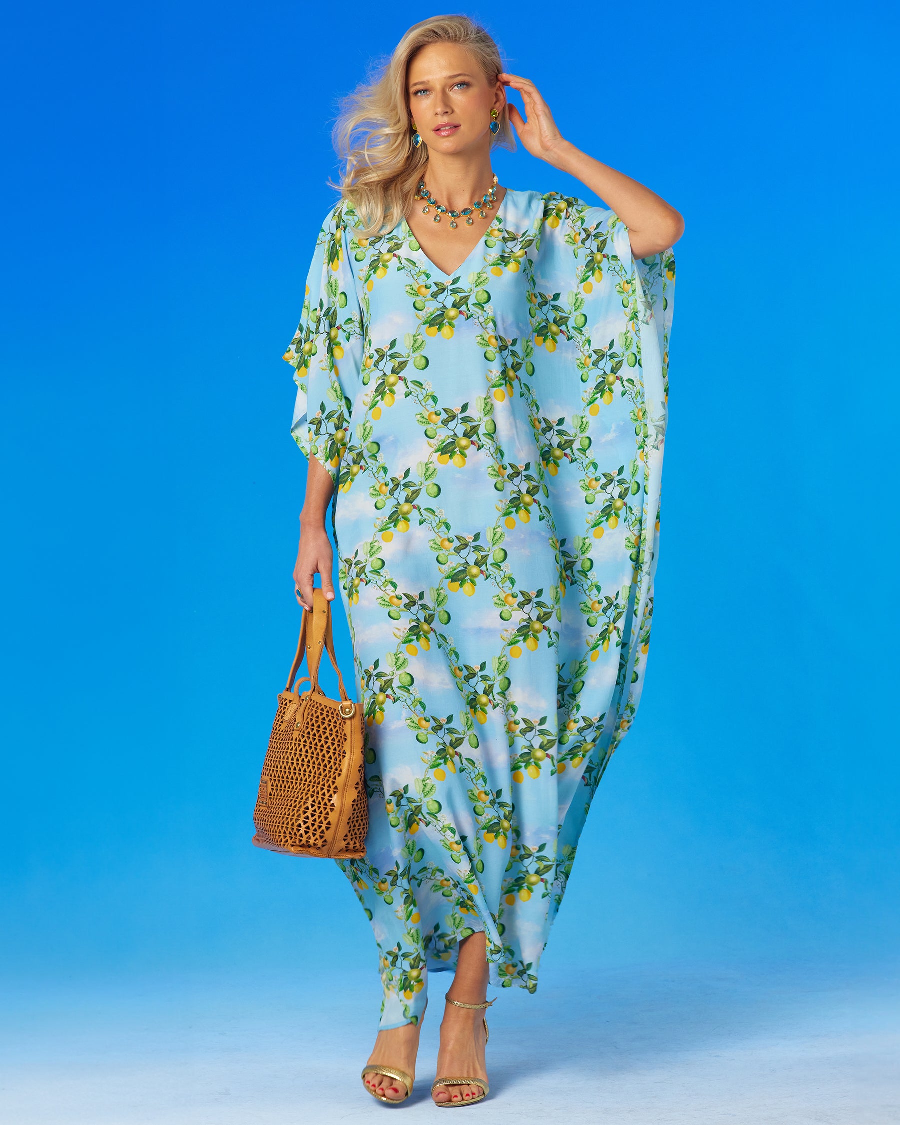 Woman wering the Annabelle Kaftan with her arm raised.