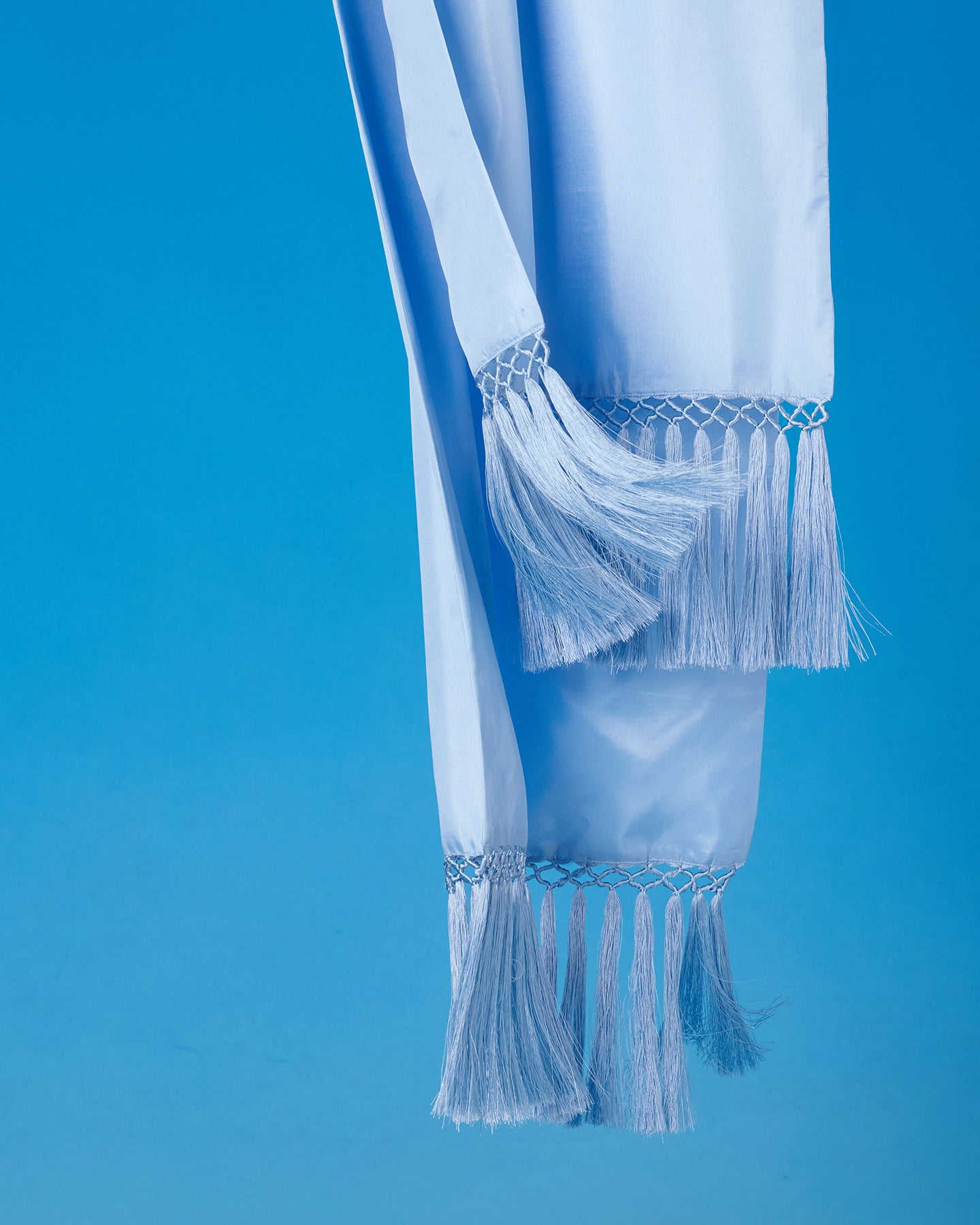 The Arabella Fringe Shawl in Robin Egg Blue blowing in the wind