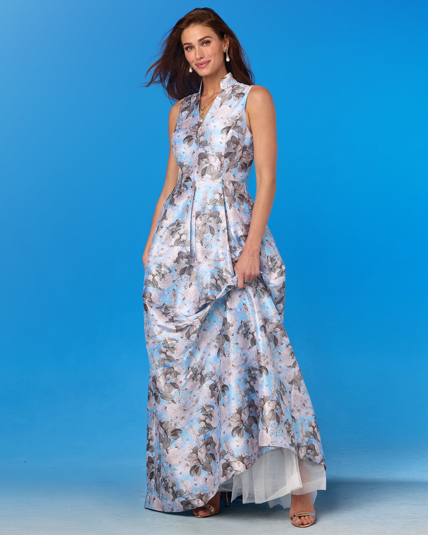 Woman wearing a floral dress against a blue background