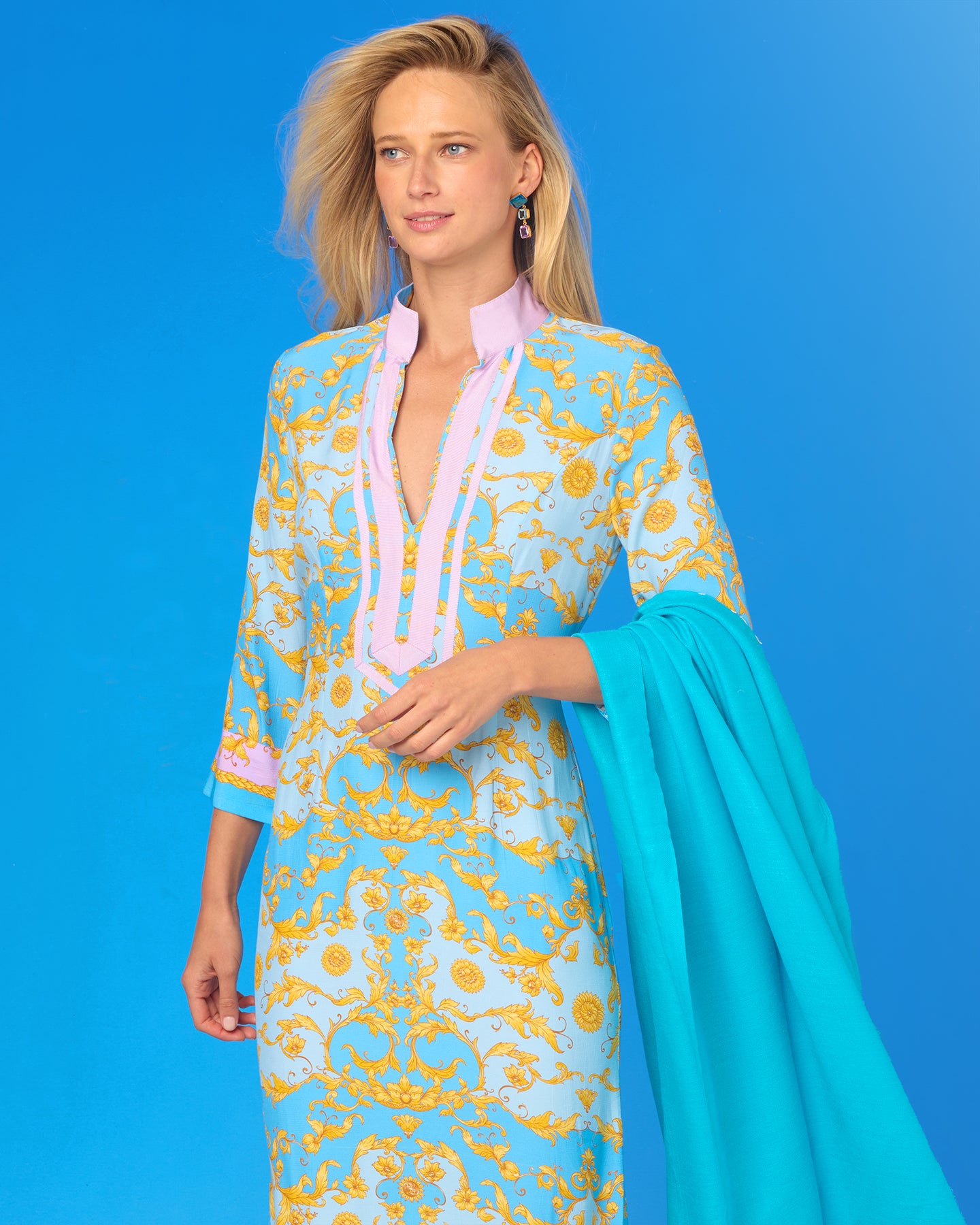 Woman wearing a colorful dress with a blue background
