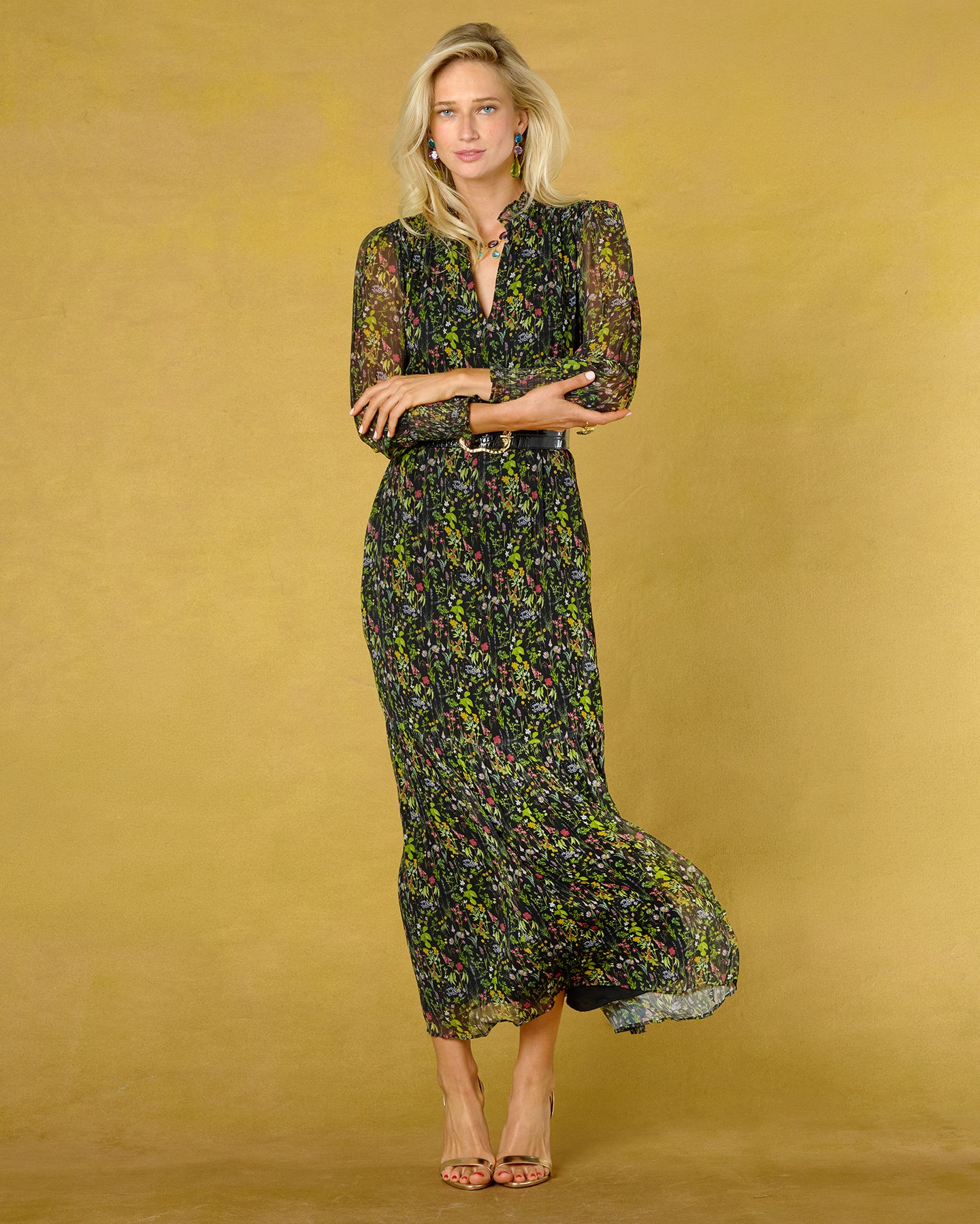 Woman wearing a floral dress against a mustard yellow background