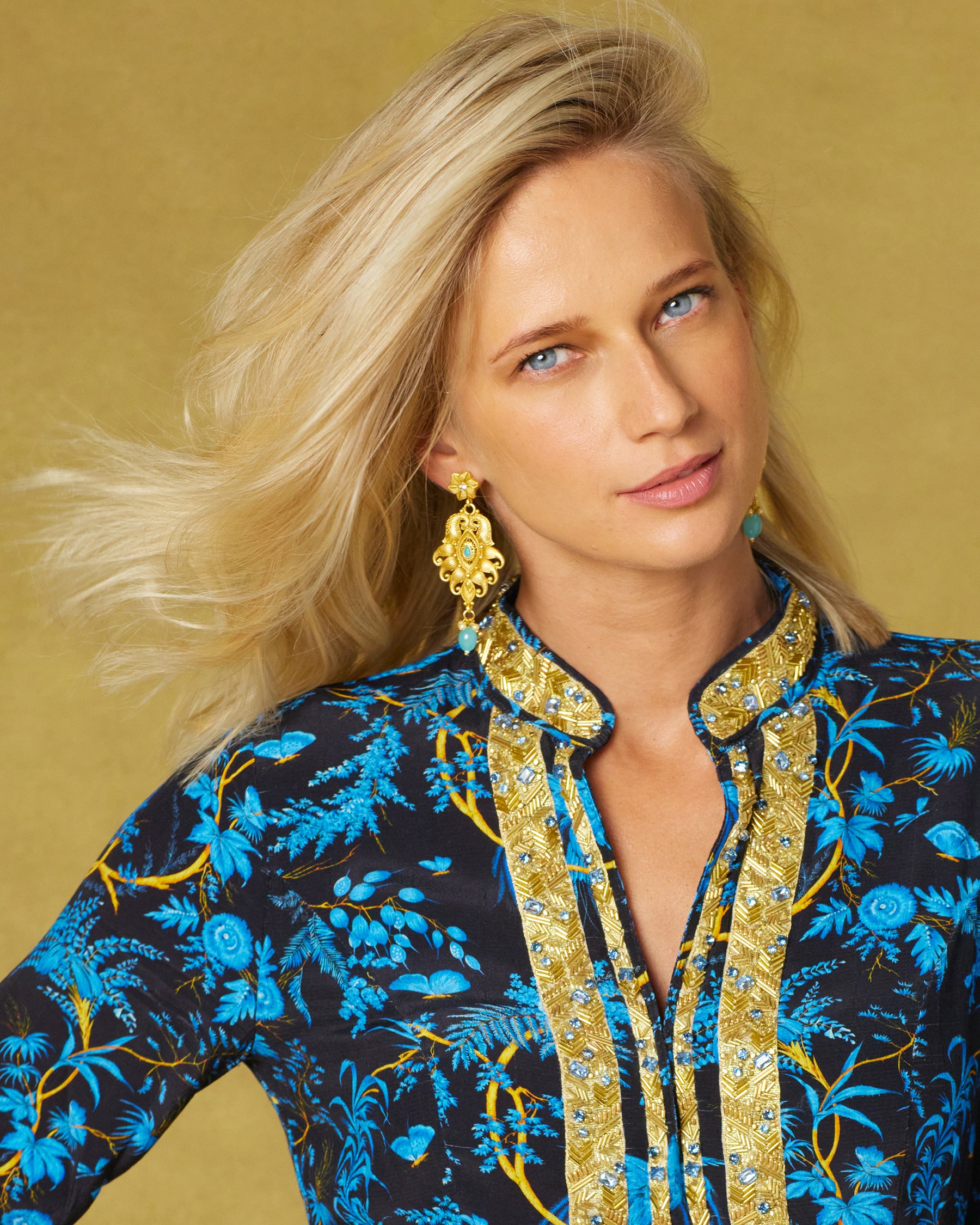 Closeup portrait view of the Darcy Tunic in Midnight Garden with Gold Embellishment worn with the Aria Filigree Gold Earrings and Turquoise