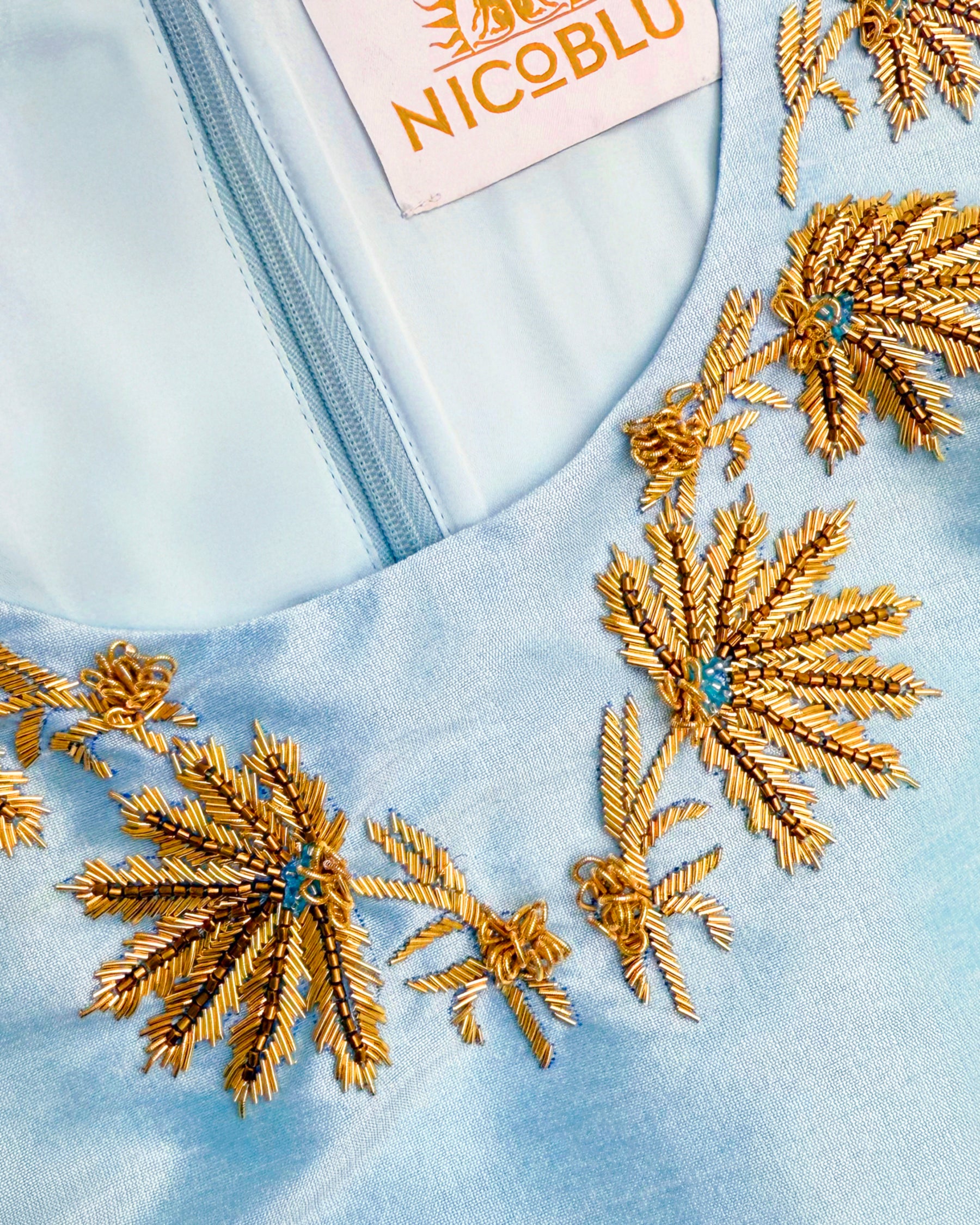 Neckline embellishment detail of the Alice Long Sheath Dress in Pastel Blue and Gold Embellishment