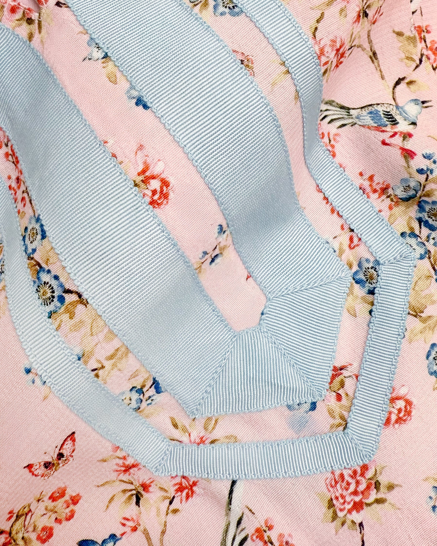 Neckline detail of the Capri Long Tunic Dress in Delicate Blue Blossoms on Blush Pink