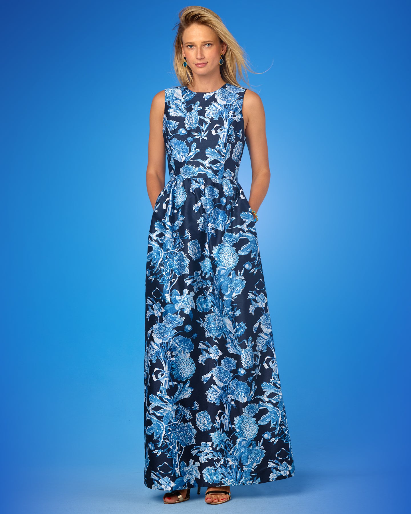 Woman wearing a blue floral dress against a blue background
