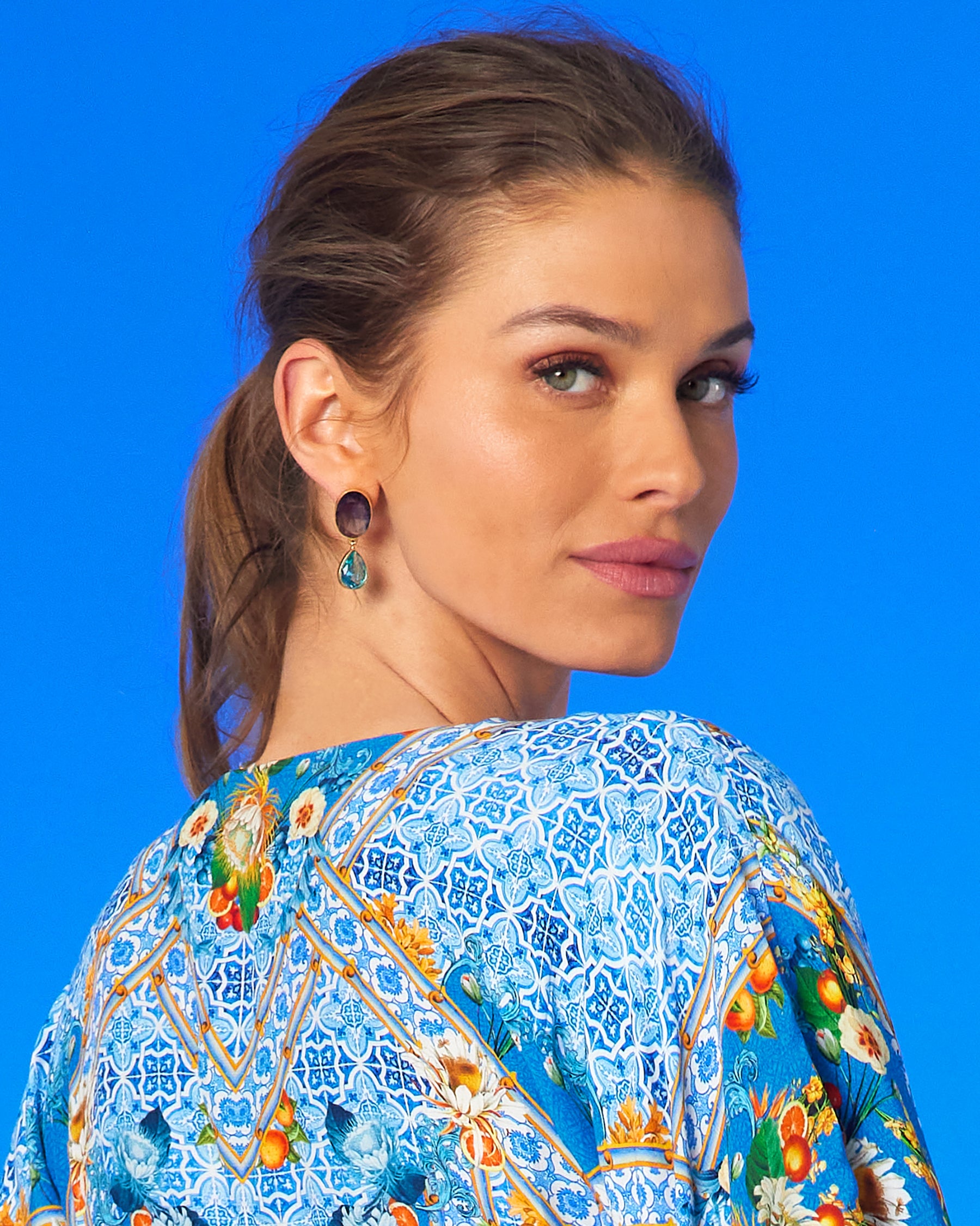 Fiorella Cinched Long Kaftan in Porcelain Print worn with the Chiara Dewdrop Earrings in Amethyst Purple and Crystal Blue