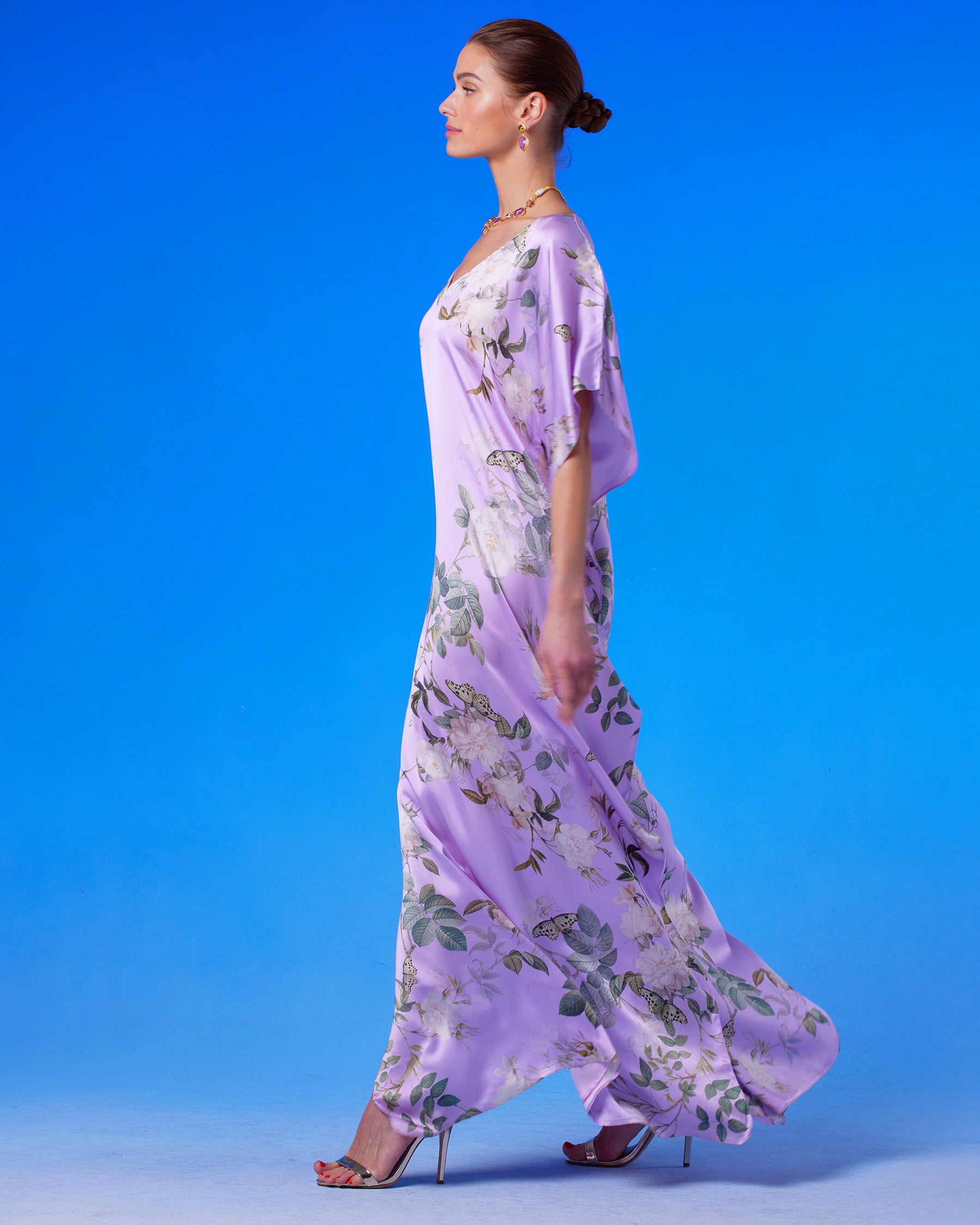 Gwendolyn Silk Kaftan in English Garden profile view with the silk kaftan blowing in the wind