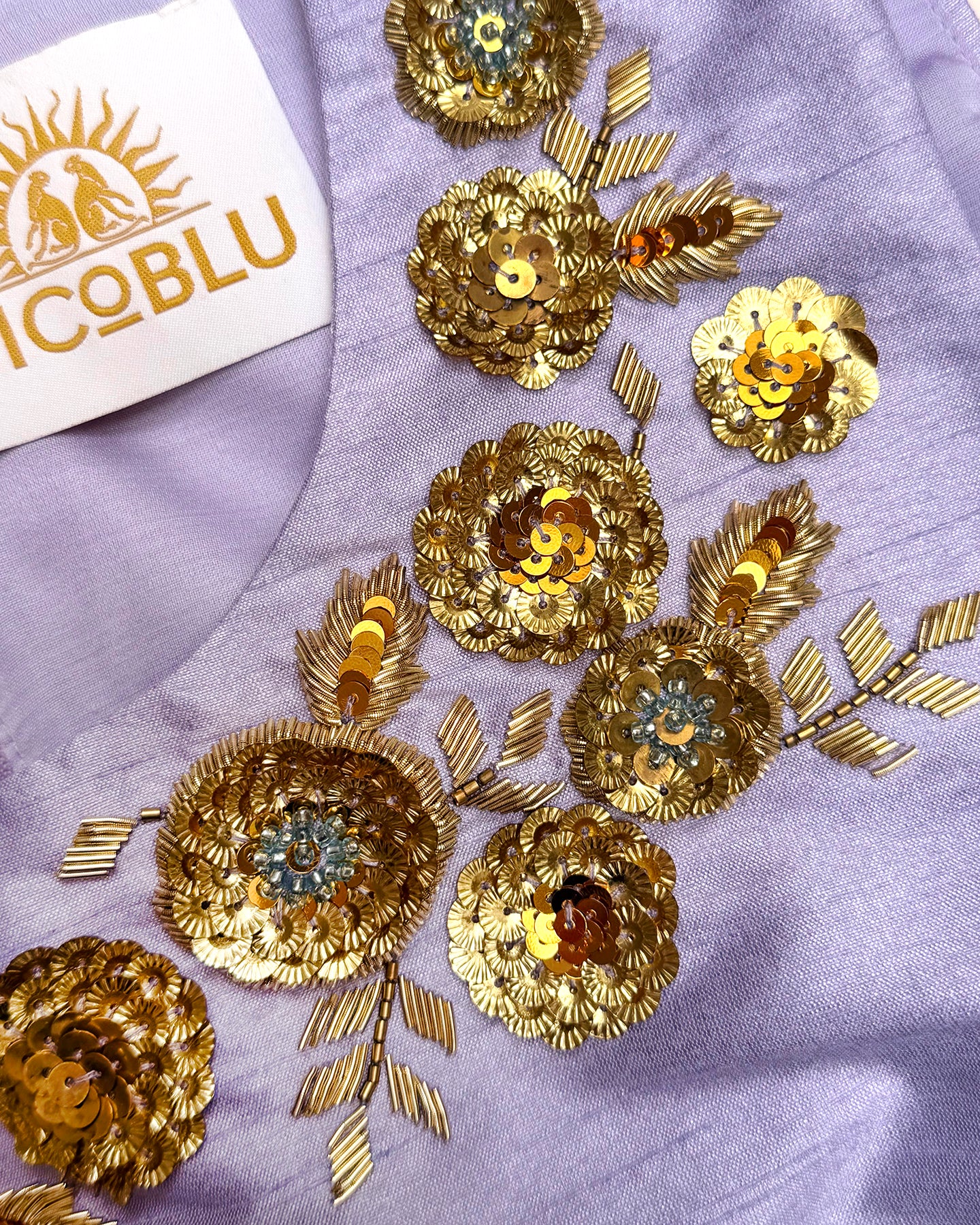 Detail of hand-crafted gold floral embellishment on a lavender dupioni dress collar.
