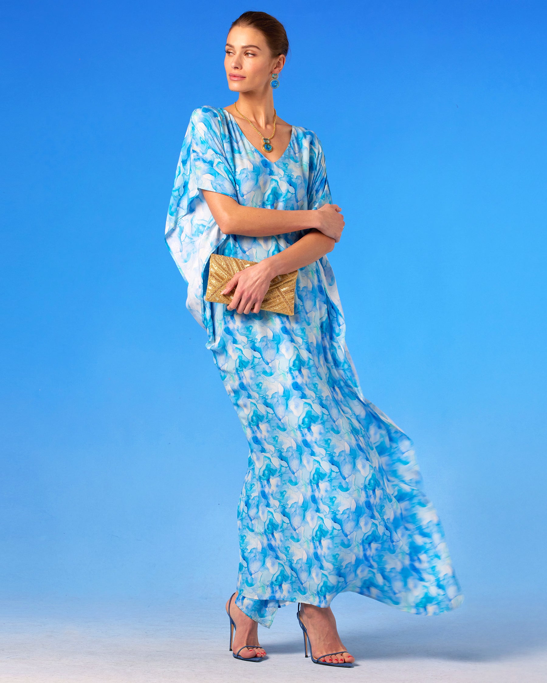 Isla Kaftan in Sea Swirl Blues standing with kaftan fluttering in the wind