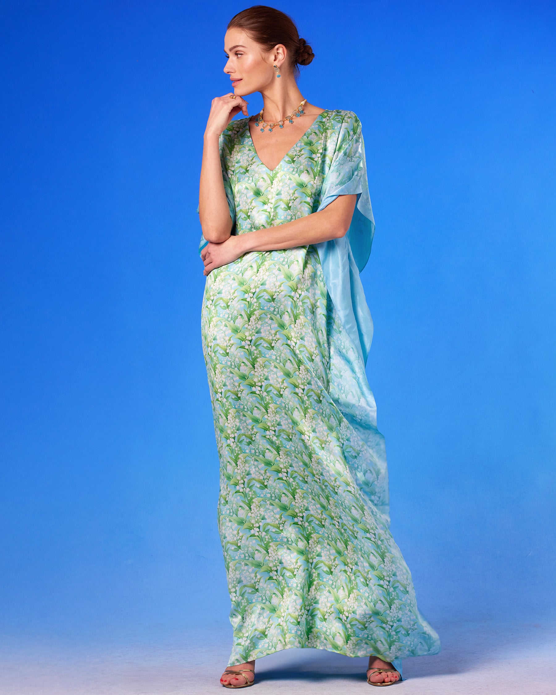 Julia Silk Kaftan in Lilies of the Valley with arm up and looking to the side