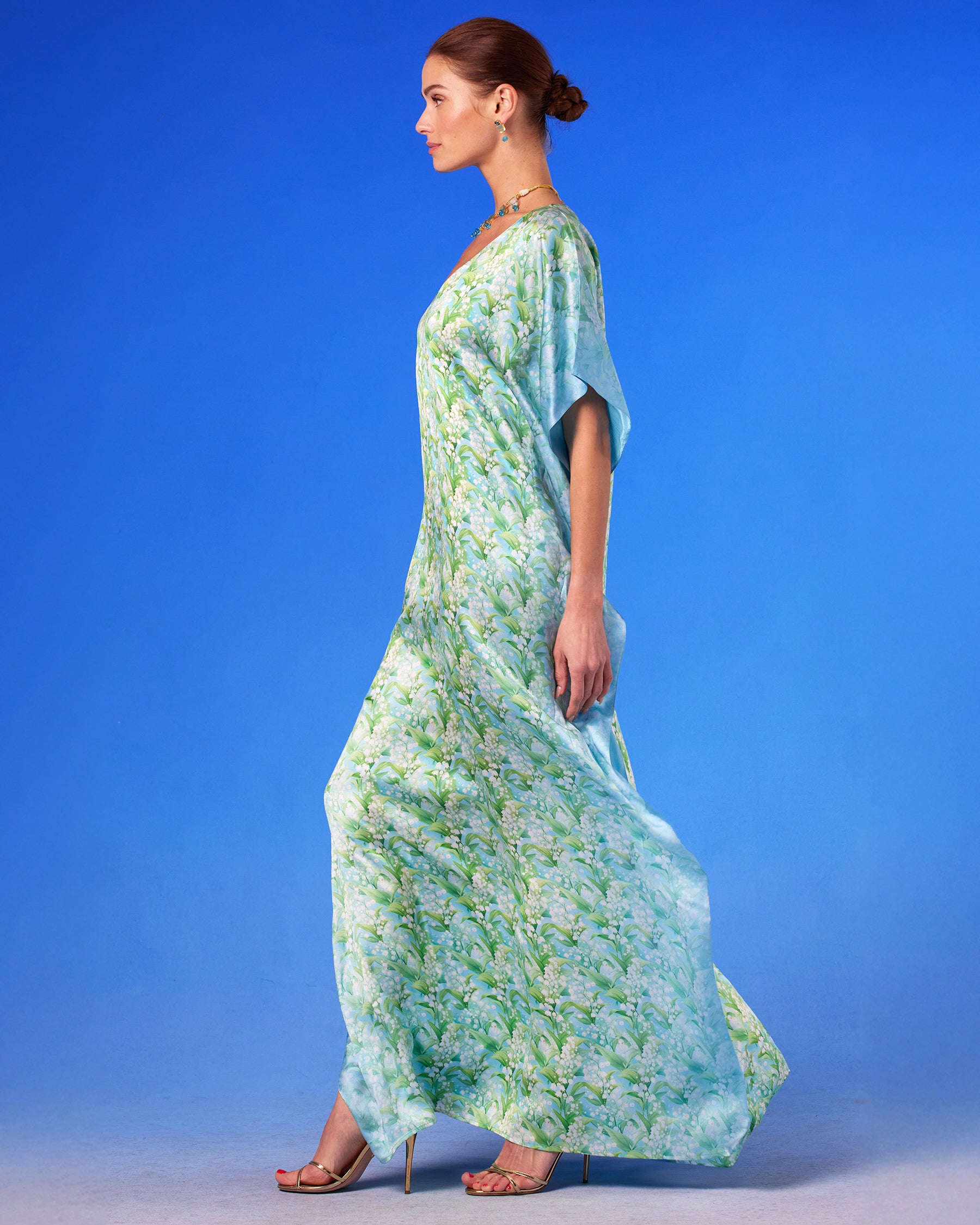 Julia Silk Kaftan in Lilies of the Valley side vie with arms down and kaftan blowing in the wind