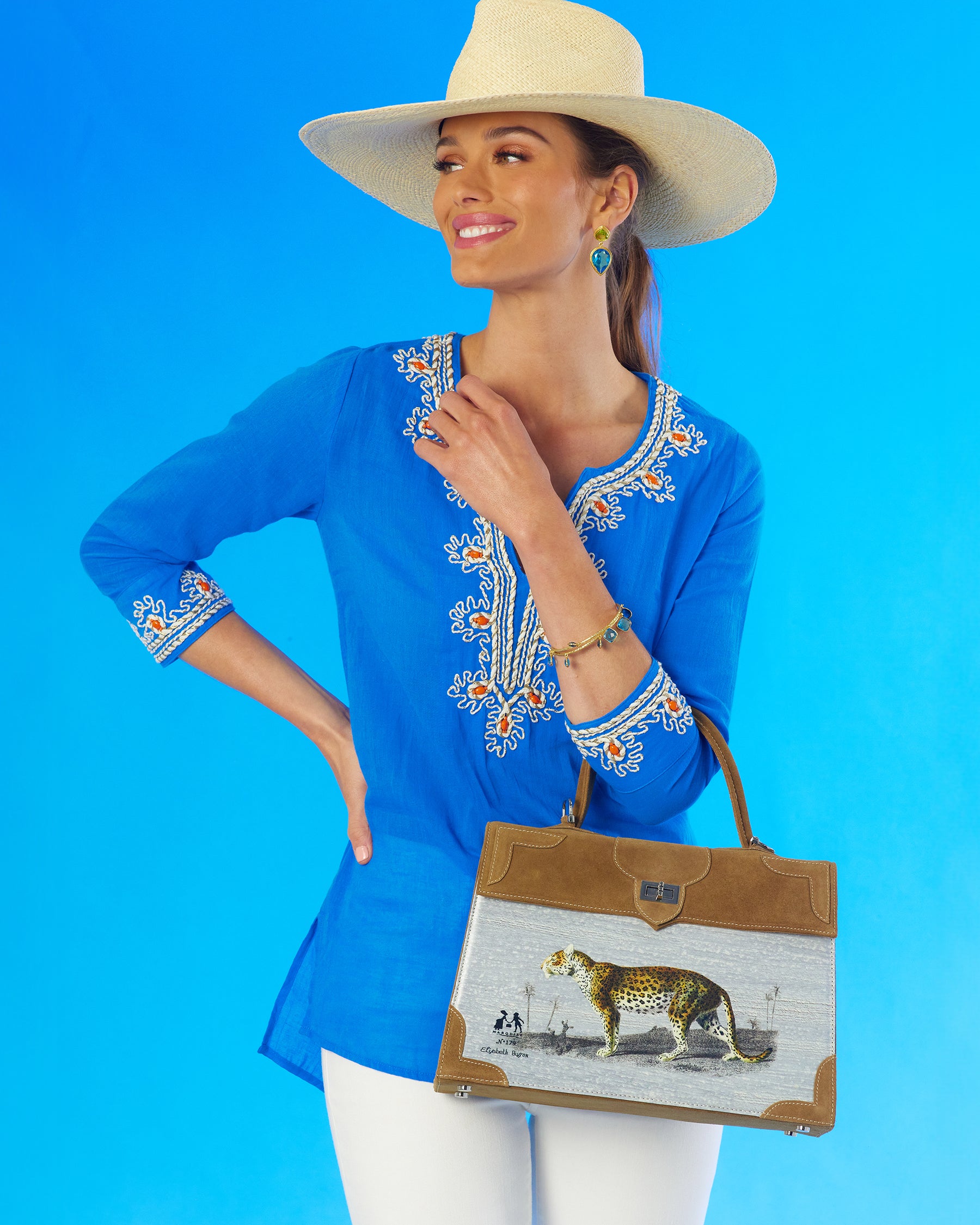 Mallorca Tunic with Coral Embellishment wearing the Marquise Paris La Panthère Top Handle Shoulder Bag in Golden Oakslung over arm