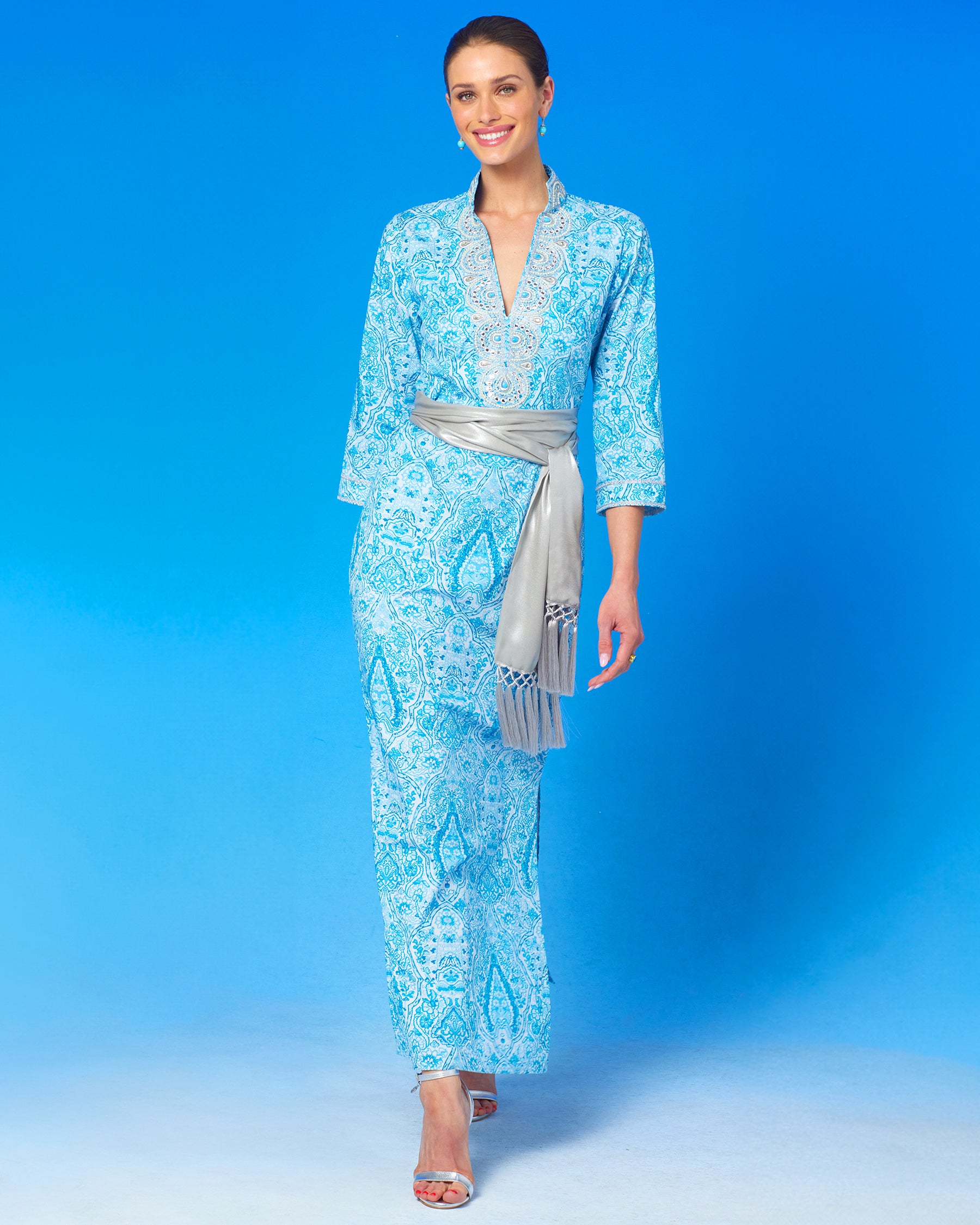Noor Long Tunic Dress in Turquoise Paisley and Silver Embellishment with waist cinched with the Cosima Silver Sash Belt-front view walking