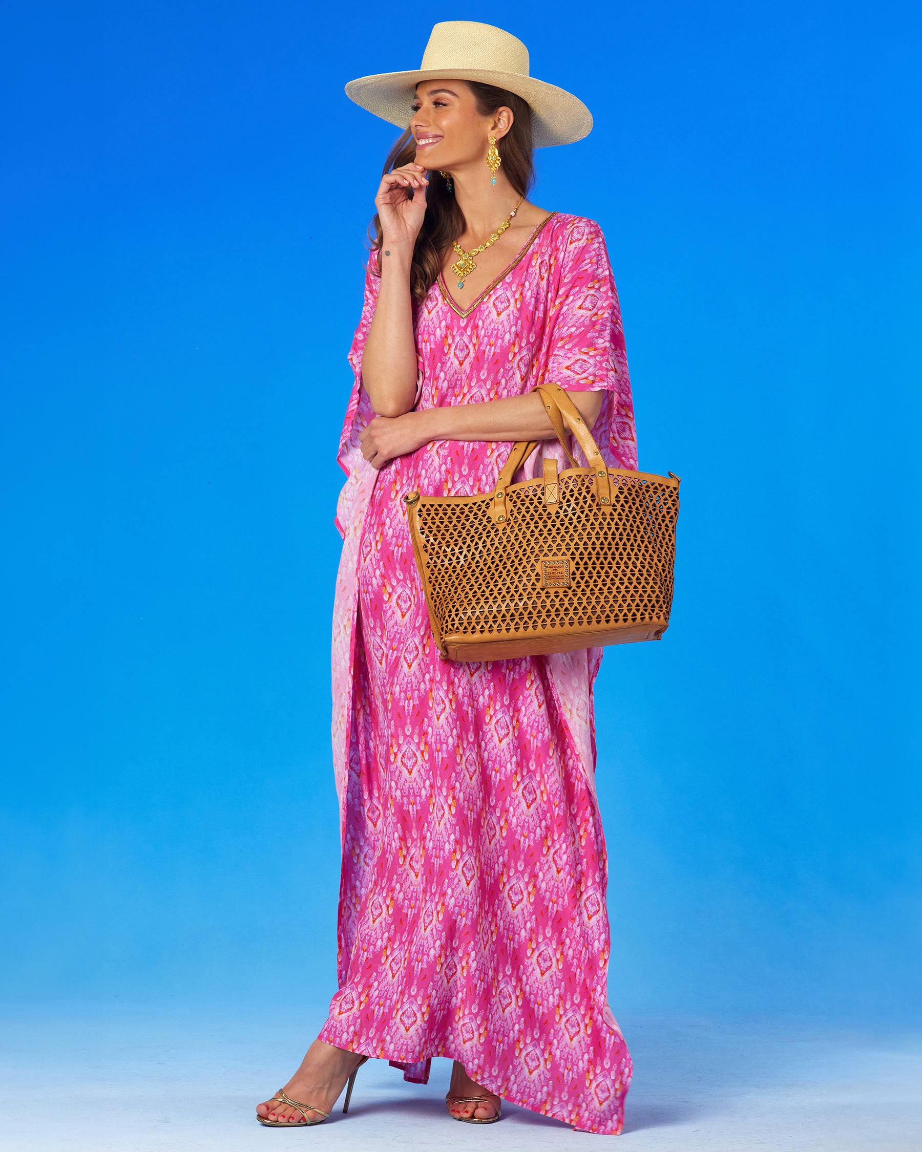 Orchidea Kaftan in Fuchsia Pink Ikat and Gold Beaded Trim with Campomaggi Malibu Pyramid Cut Tote Bag in Tanslung over the arm, full view