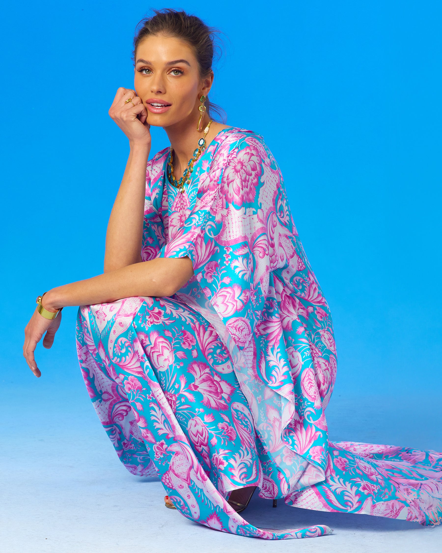 Shalimar Silk Kaftan in Pink and Blue-crouching and looking at the audience