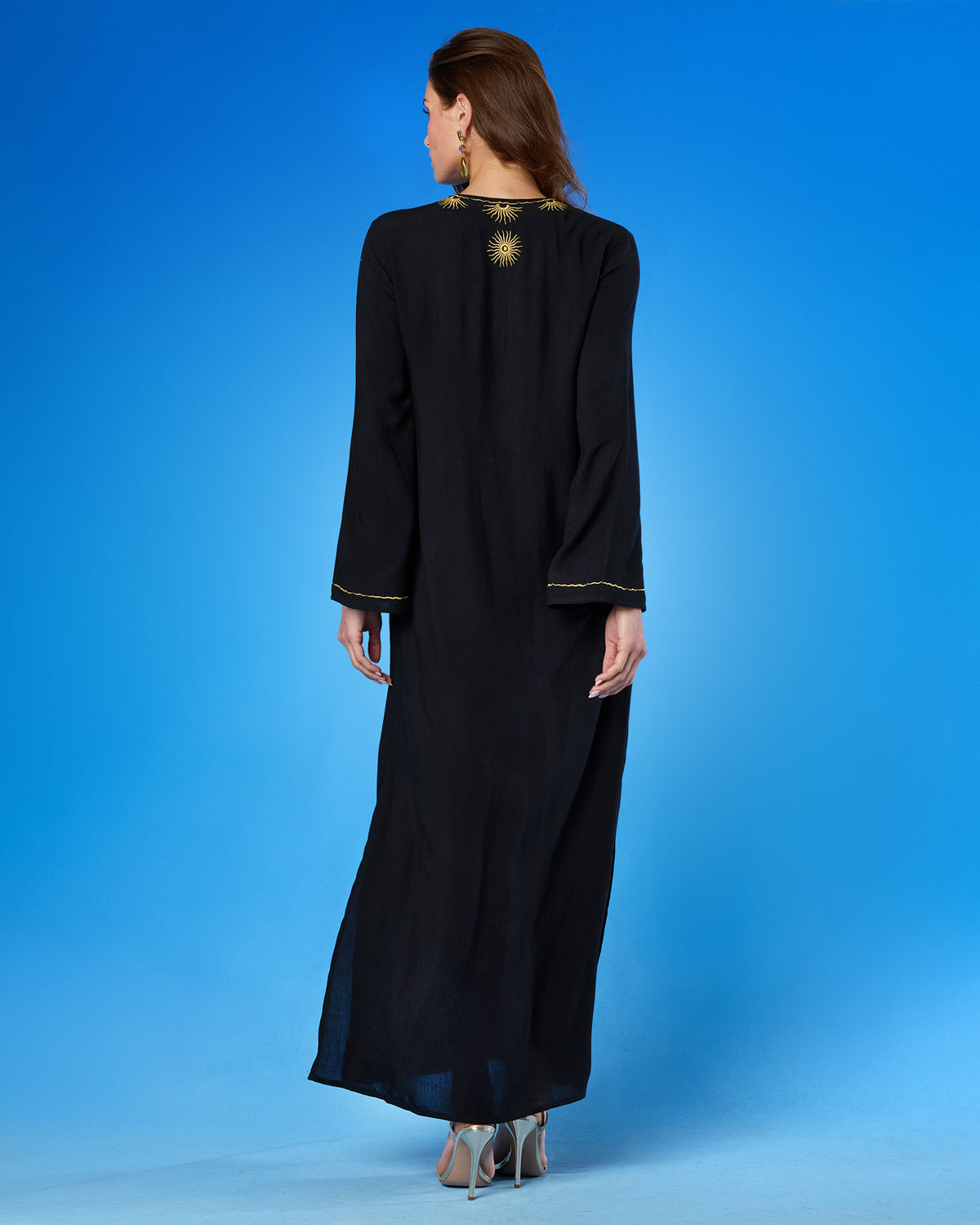 Woman wearing the Soleil Long Kaftan Coverup Dress and in Black and Gold Embroidery viewed from the back