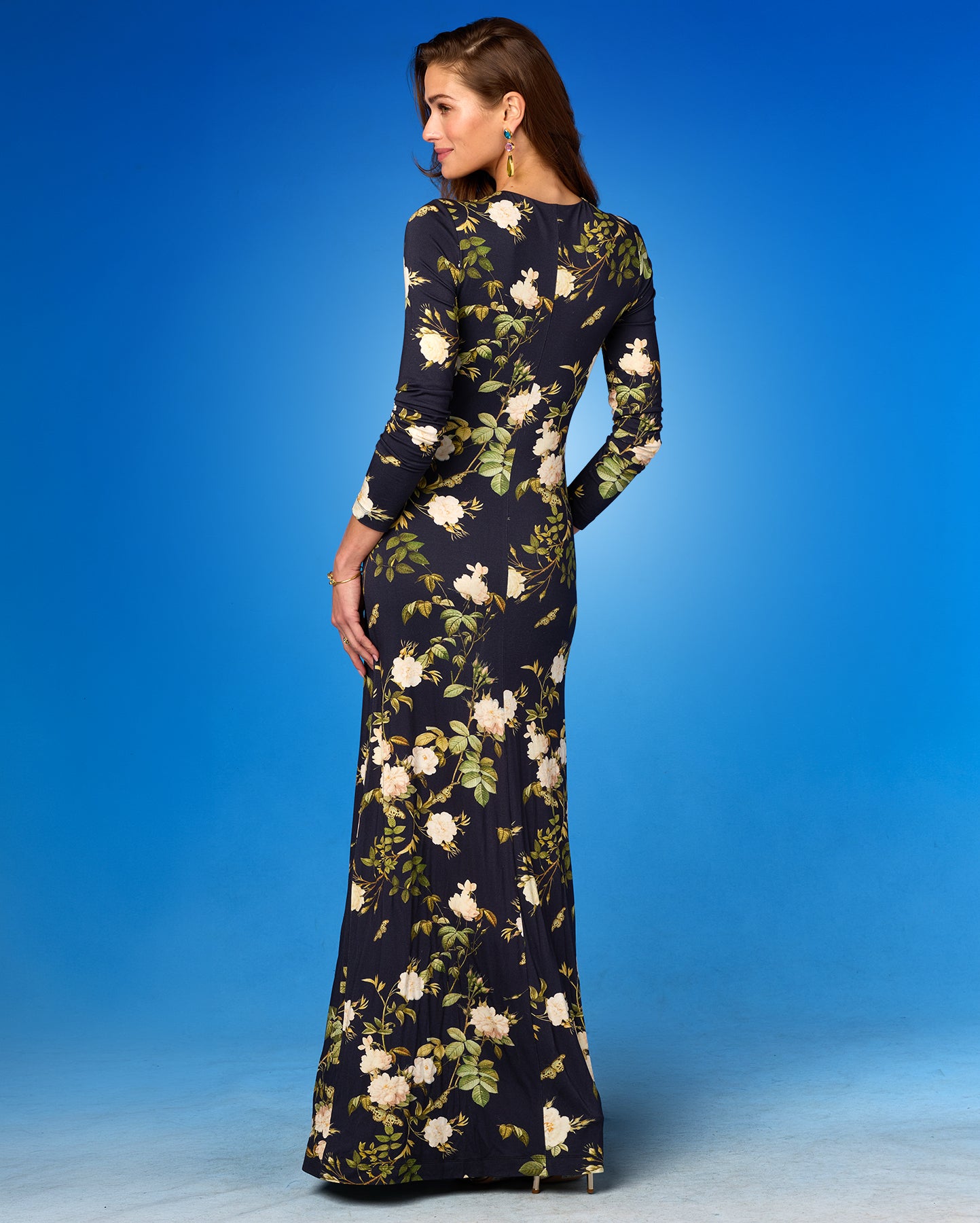 Woman wearing a floral dress against a blue background