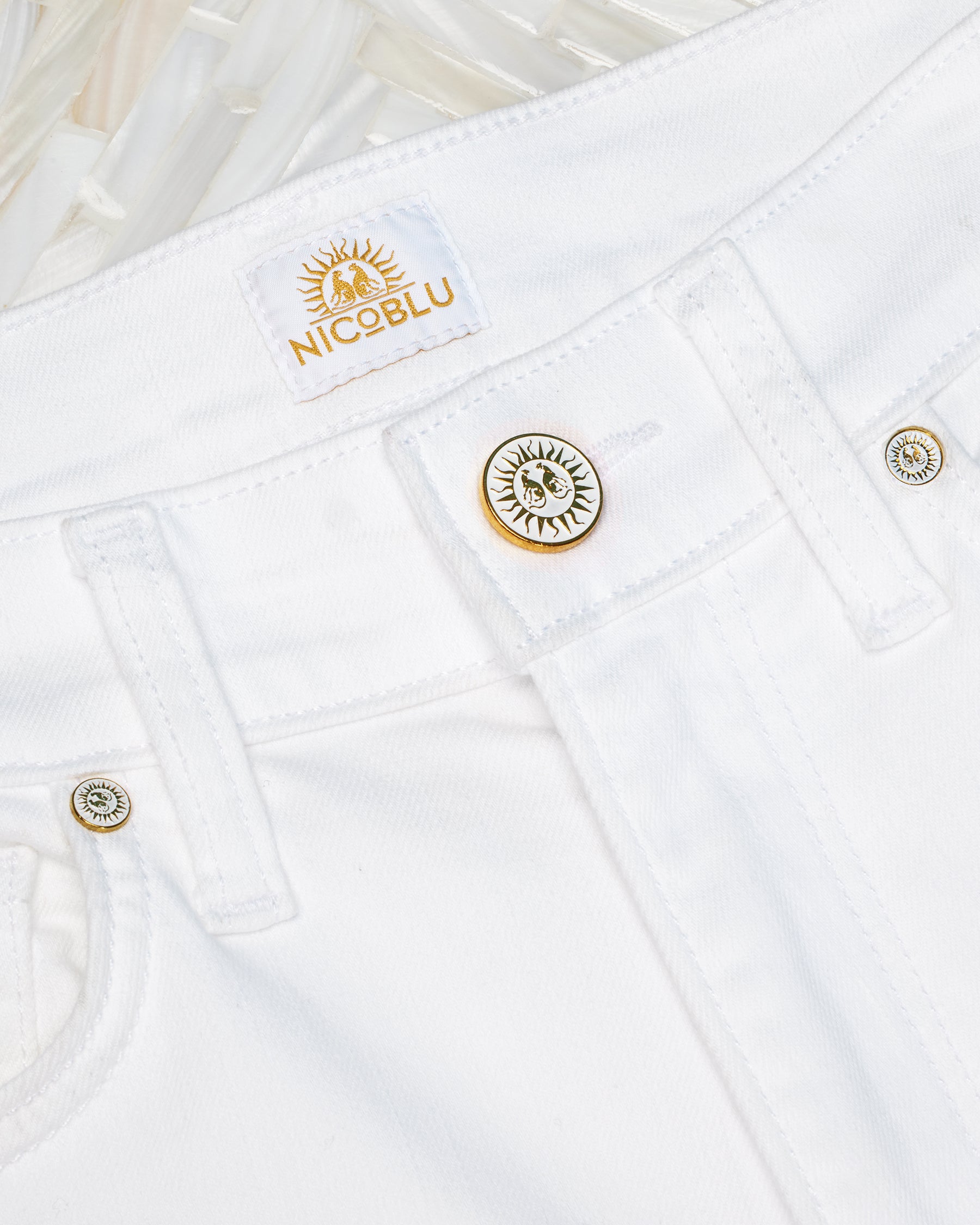 Details showing the wide belt loops and NicoBlu button closure and grommets of theKatherine Slim White Jean