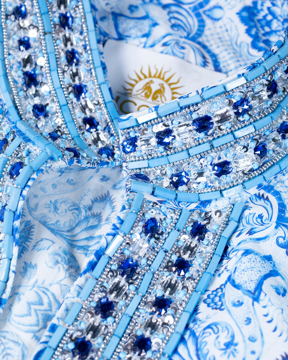 Closeup of turquoise and sapphire crystal embroidery on a tunic
